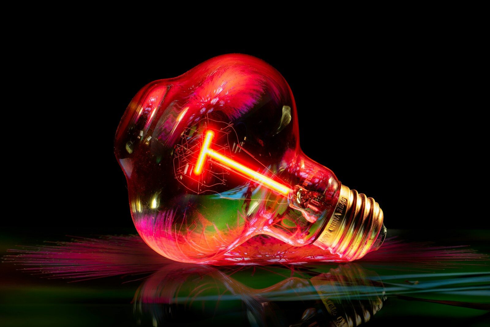 A glowing red light bulb with a bright filament.